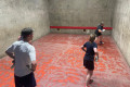 Richard Christie serving at the Rugby & Eton Fives Medley at Marlborough